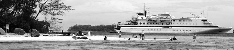 The Clipper Odyssey anchored next to John F. Kennedy Island (foreground) in the Solomon Islands. This is the tiny island where future President JFK swam ashore after his PT-109 was cut in half by a Japanese destroyer in World War II. Photo: Toulmin