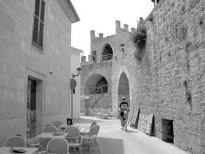 Ann biking along the old wall of Alcudia, Mallorca.