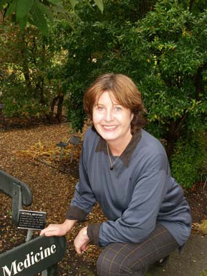 Rosie Atkins, garden curator, poses in the medicinal section of Chelsea Physic Garden.