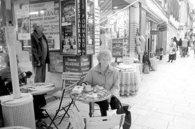 JoAnn Kofoed enjoying a cappuccino and pastry at a café in Beaune.