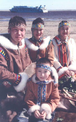 Along the Lena River, these young villagers donned traditional costumes to greet passengers of the M.V. Mikhail Svetlov, shown in the background. Photo by Jim Delmonte<br />
