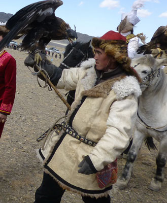 A hunter at the festival holds his 18-pound female golden eagle high.