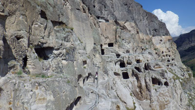 Cave town of Vardzia, Georgia. Note people on stairway at left. 