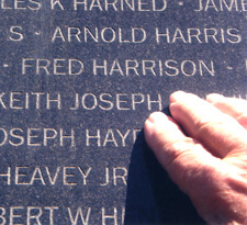 Wayne Buxton pointing out the name of his friend Fred Harrison at the Wall of Remembrance in the UN Memorial Cemetery in Busan. Photo by Janice Buxton