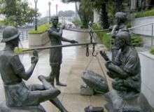 “A Great Emporium,” by Malcolm Koh, is one of four sculptures in the historically themed “People of the River” series along the Singapore River in Singapore.