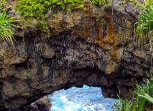 On Tonatapu island in Tonga, the Hufangalupe Archway, a land bridge over the crashing waves of the Pacific, formed when the roof of a sea cave collapsed. Photo ©donyanedomam/123rf.com