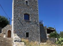 A tower-house in Kokkala, Greece, with steps leading to a small bay. Photos by Linda Huetinck