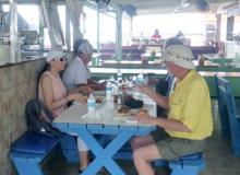 Left: Dining at the lolo Sky’s the Limit in Grand Case, Saint-Martin. Right: A smoking oven in use at Sky’s the Limit. Photos by Randy Keck