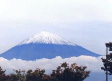 The nearly symmetrical cone of Japan’s Mt. Fuji towers over the clouds.