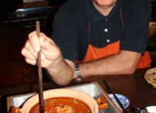  John Scott checking on the Caramel Pork in Clay Pot.