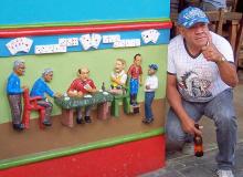 A Guatapé local poses by a pub-front “socket” for which he served as a model.