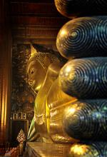 Toes of the 46-meter-long reclining Buddha at Wat Pho temple in Bangkok, Thailand. The figure was built with bricks, shaped with plaster, then gilded.