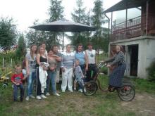 Mary Anne Christie (center) with Stasia (on bike) and her family at their home i