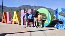 This sign sits atop Mount Alamos. Left to right: Tom and Lynn Meadows and friends Vince and Susan.