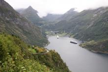 Geiranger village seen from Ørnesvingen (Eagle’s Bend) Lookout. The road to the lookout is full of hairpin curves like the one on the left. Photo: Prindle