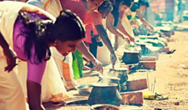 Women cooking at a religious festival in Kerala, southwestern India.