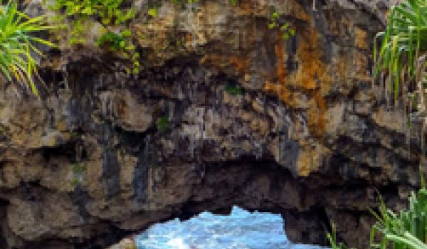 On Tonatapu island in Tonga, the Hufangalupe Archway, a land bridge over the crashing waves of the Pacific, formed when the roof of a sea cave collapsed. Photo ©donyanedomam/123rf.com