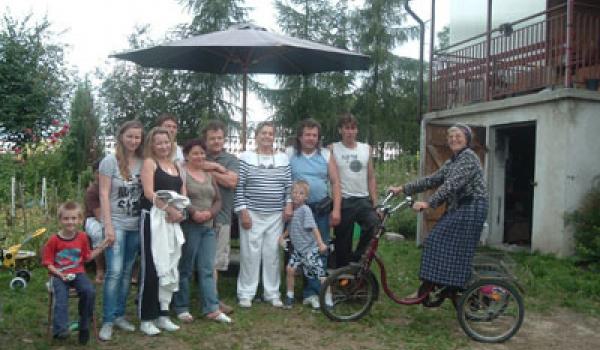 Mary Anne Christie (center) with Stasia (on bike) and her family at their home i