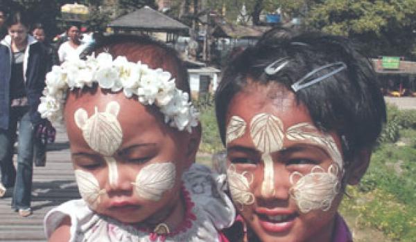 Woman and child with faces decorated — Mandalay