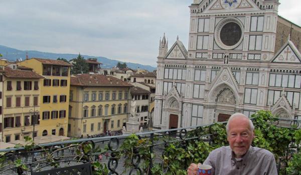 Paul Lalli at breakfast on the terrace of “Miravista” in the Palazzo Antellesi, with the church of Santa Croce visible in the background.