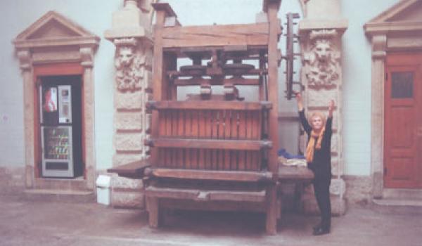 JoAnn Kofoed beside an antique wine press in Beaune. Photo: Bill Kofoed  