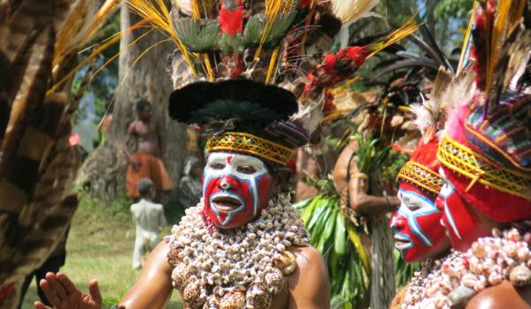 Iridescent beetles are woven into the headbands of these Wahgi Valley women.