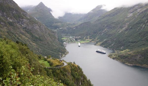 Geiranger village seen from Ørnesvingen (Eagle’s Bend) Lookout. The road to the lookout is full of hairpin curves like the one on the left. Photo: Prindle