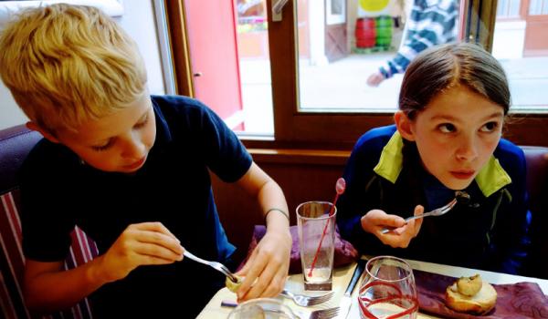 Travelers of all ages — here trying snails for the first time — can reach new gastronomic heights in France. Photo by Rick Steves