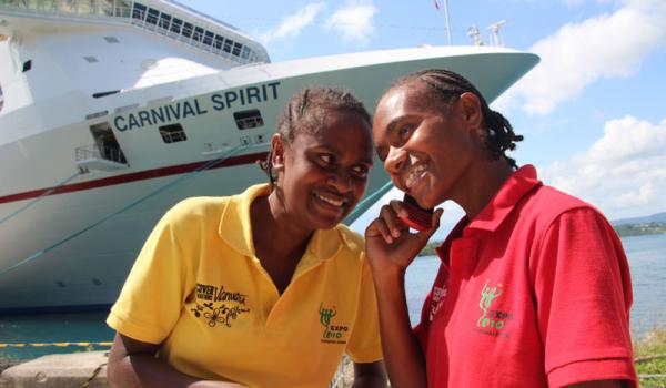 Local girls chatting on the phone in front of a Carnival Cruise Lines ship in Port Vila. Photos by Lew Toulmin