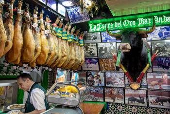 Tapas bars proudly hang ham hocks — and bullfighting memorabilia — as part of the decor. Photo by Cameron Hewitt