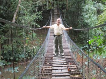 A vendor barbecues fish at Kota Kinabalu’s night market.Marvin Feldman on a swinging bridge at the Sabah Museum in Kota 