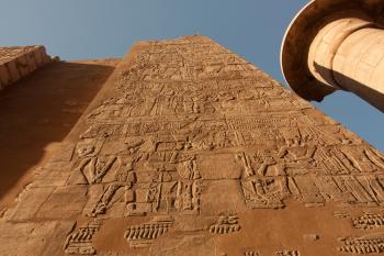 Towering carved walls at Karnak Temple. For reference, the pillar to the right is 72 feet tall.