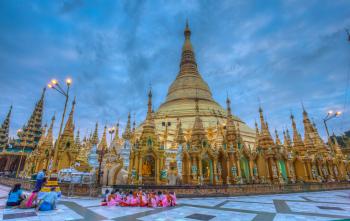 Hot-air balloon about to be launched at Taunggyi Balloon Festival.Novice nuns praying at dawn at the Shwedagon Pagoda, Yangon.