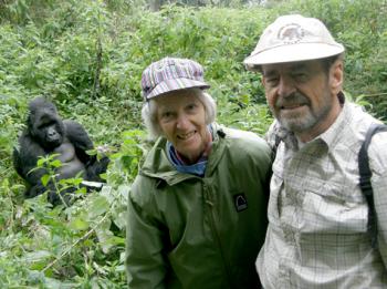 A gorilla photobombing Brenda and George Milum in Rwanda.