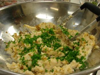 Adding parsley to beans, chickpeas and potatoes.