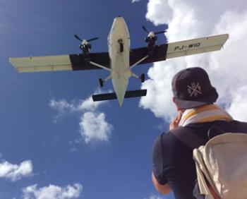 Beachgoer in Sint Maarten watching planes land.