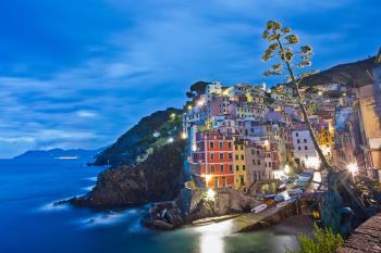 Riomaggiore, one of the Cinque Terre towns, is aglow at night. Photo by Dominic Arizona Bonuccelli